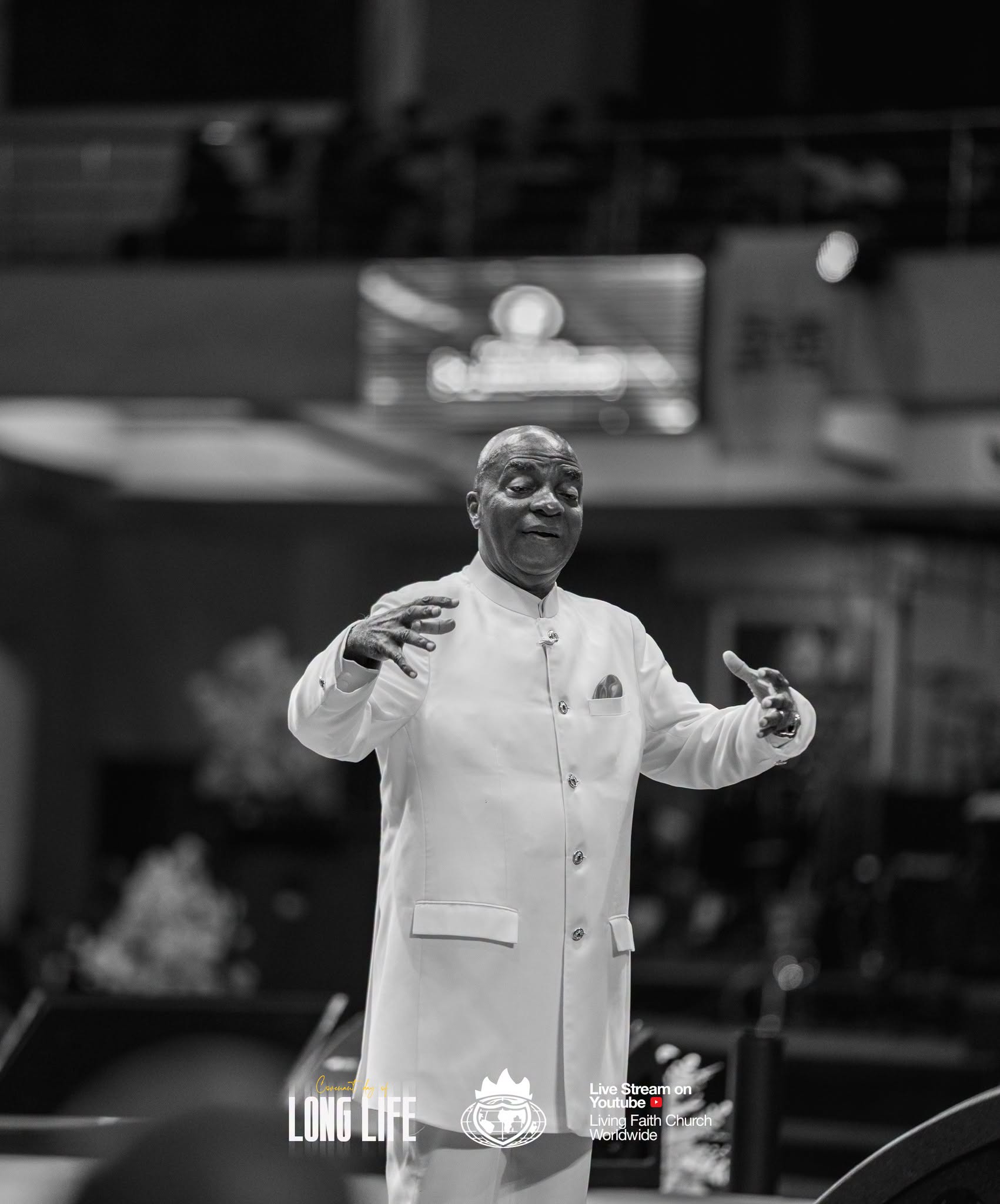 Bishop David Oyedepo gesturing as he teaches, in black and white