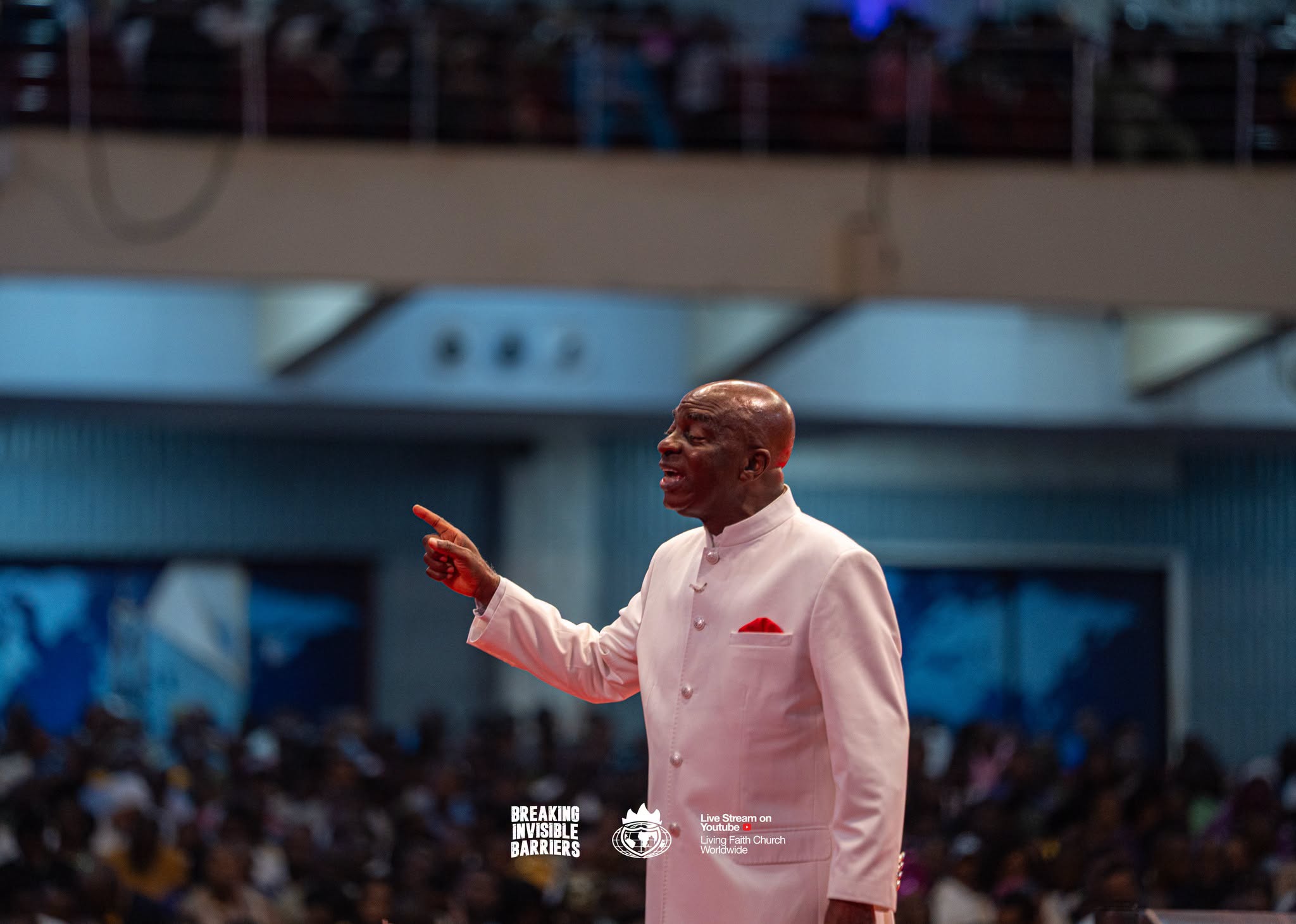Bishop David Oyedepo pointing as he teaches before a congregation